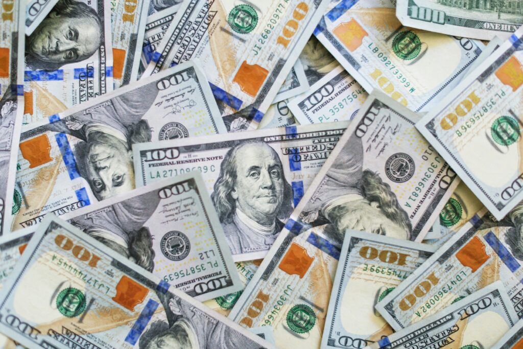 Stack of 100 hundred dollar bills featuring Benjamin Franklin and Representing Cash is King 